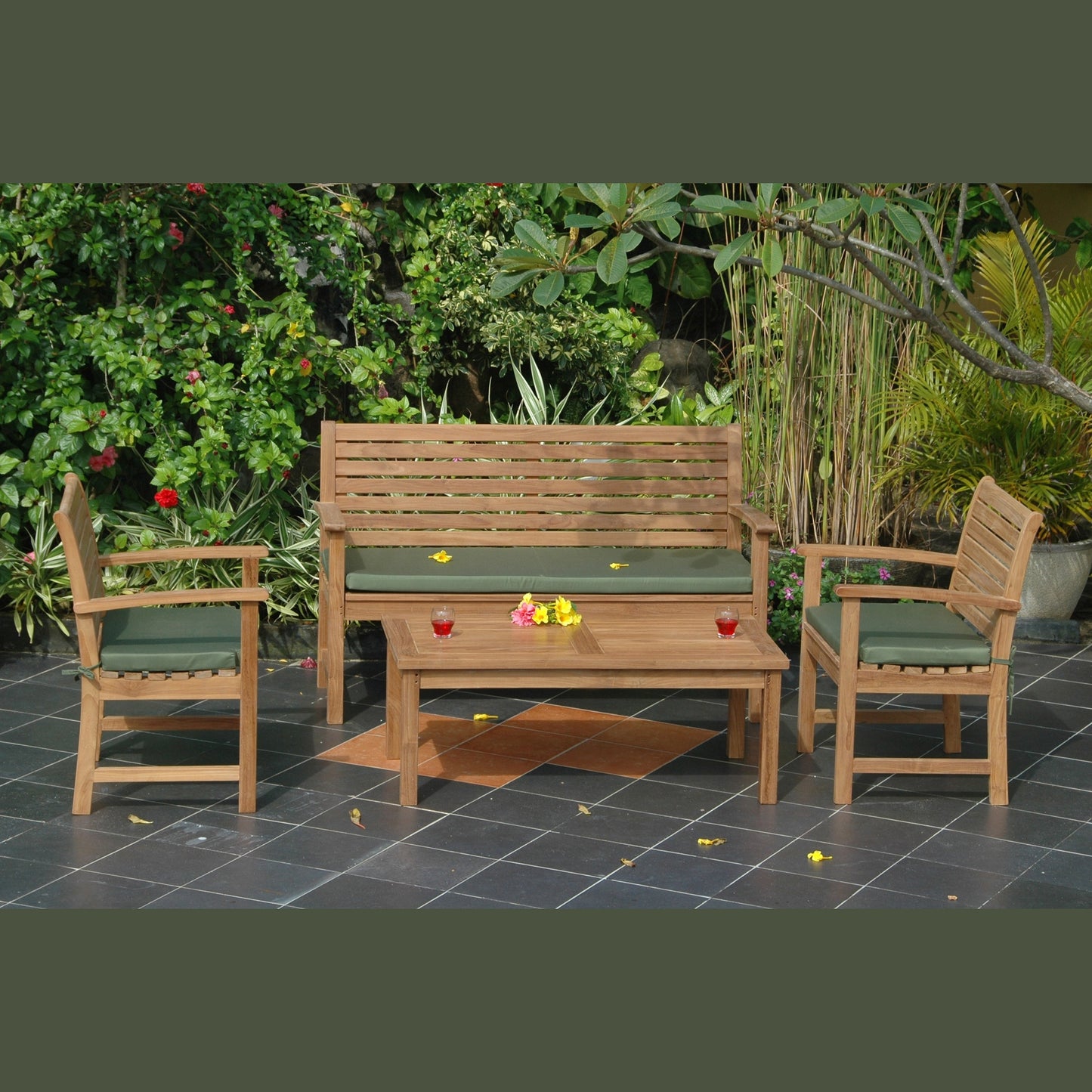 Wooden outdoor furniture set with green cushions on a patio