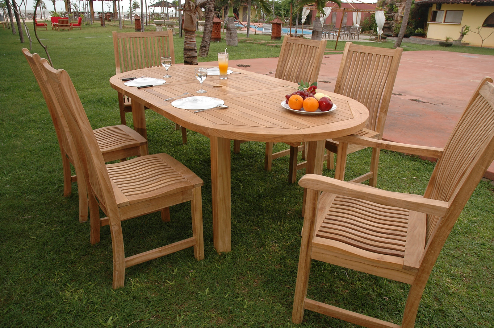 Wooden outdoor dining set with a table and chairs on grass