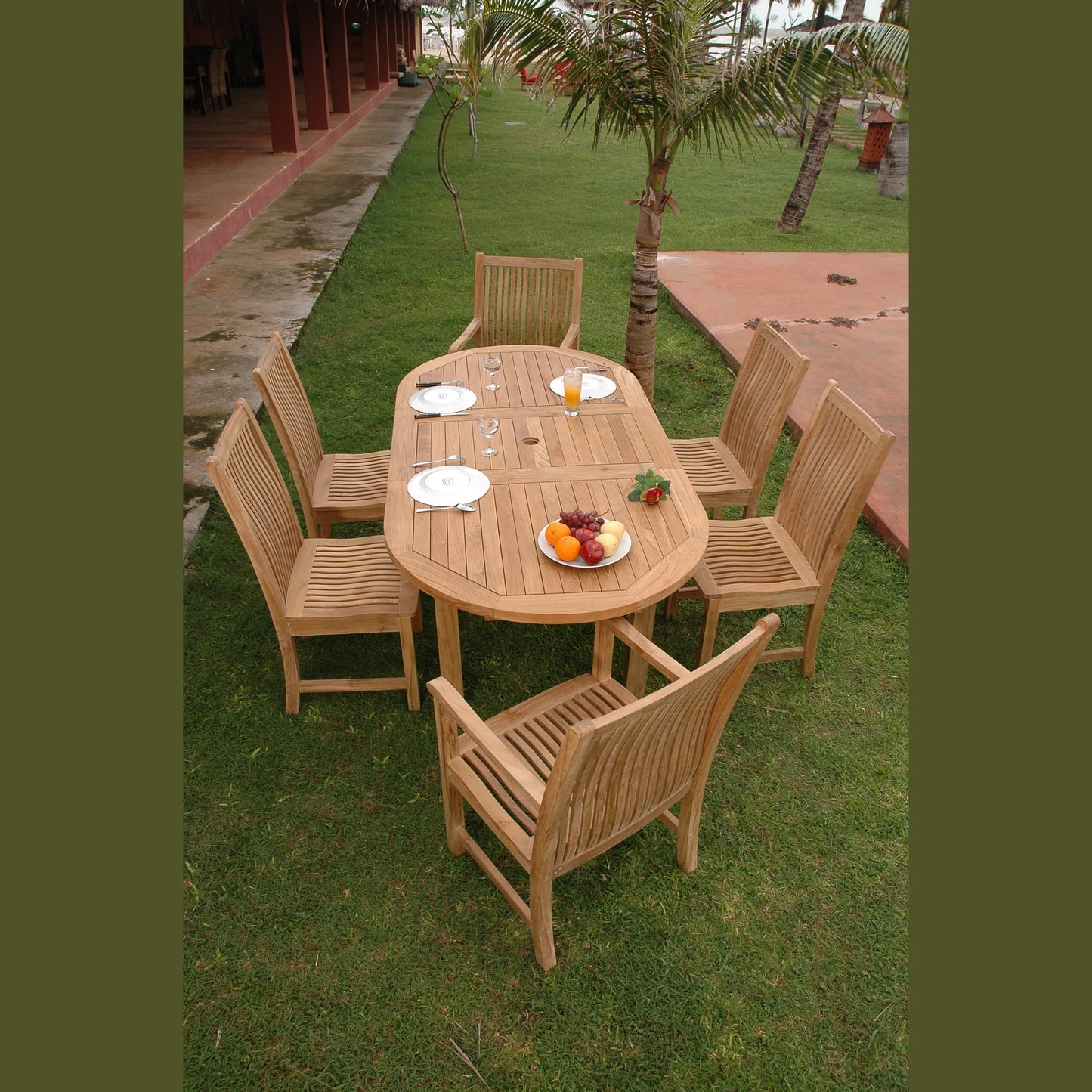 Wooden outdoor dining set with table and chairs on a grassy area.