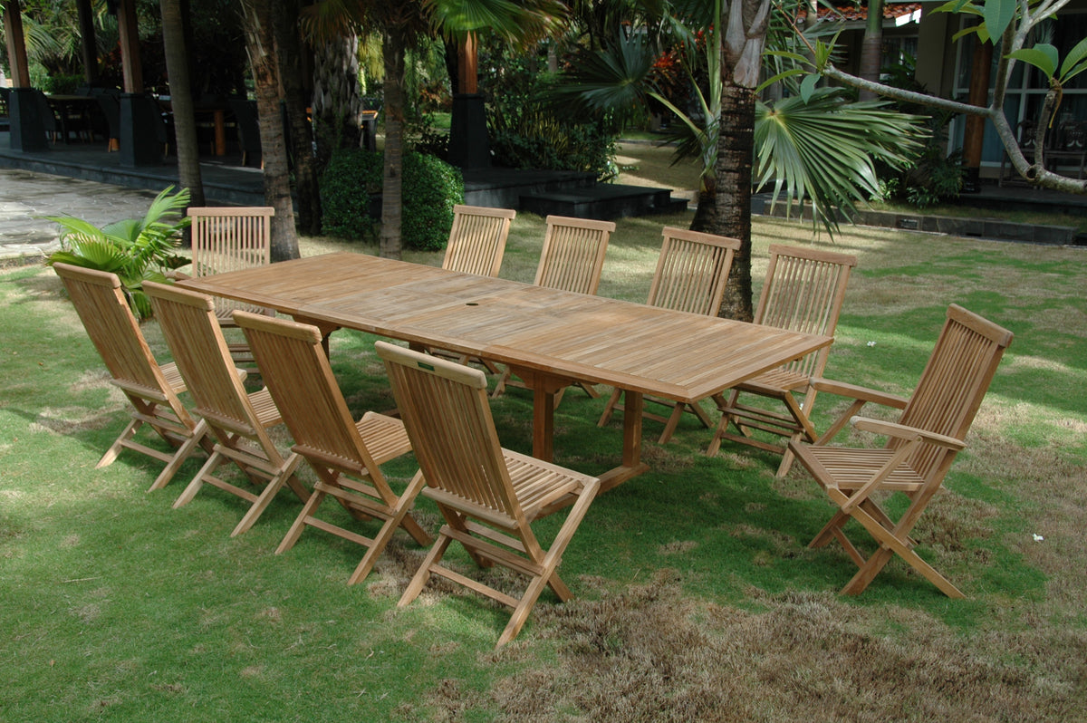 Wooden outdoor dining table with chairs on a grassy area