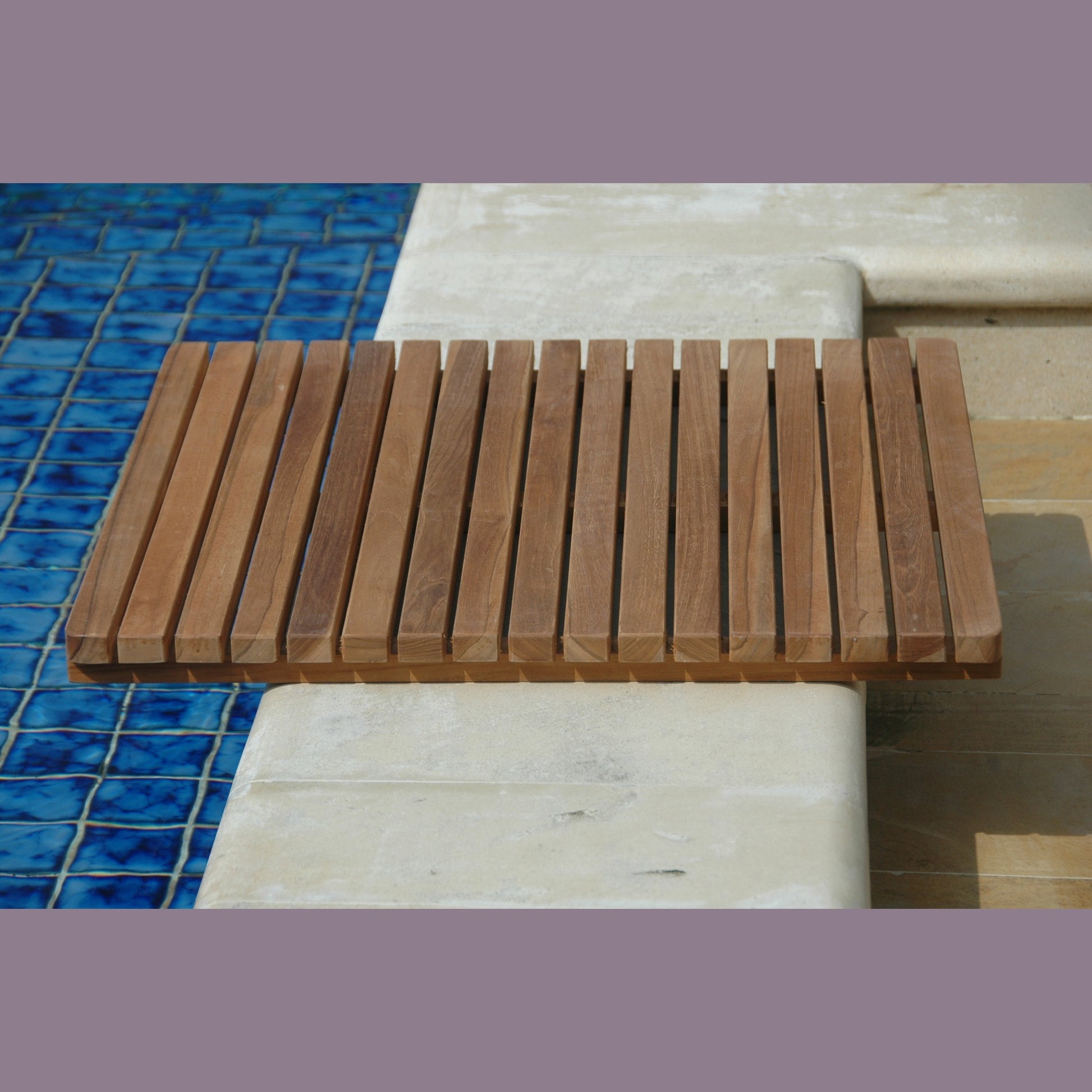 Wooden bench with slatted design on a tiled floor next to a pool.