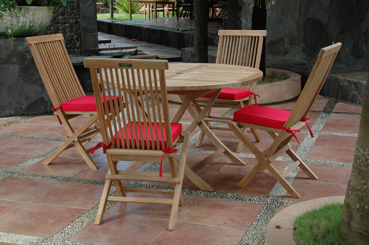 Wooden outdoor dining set with red cushions on a stone patio.