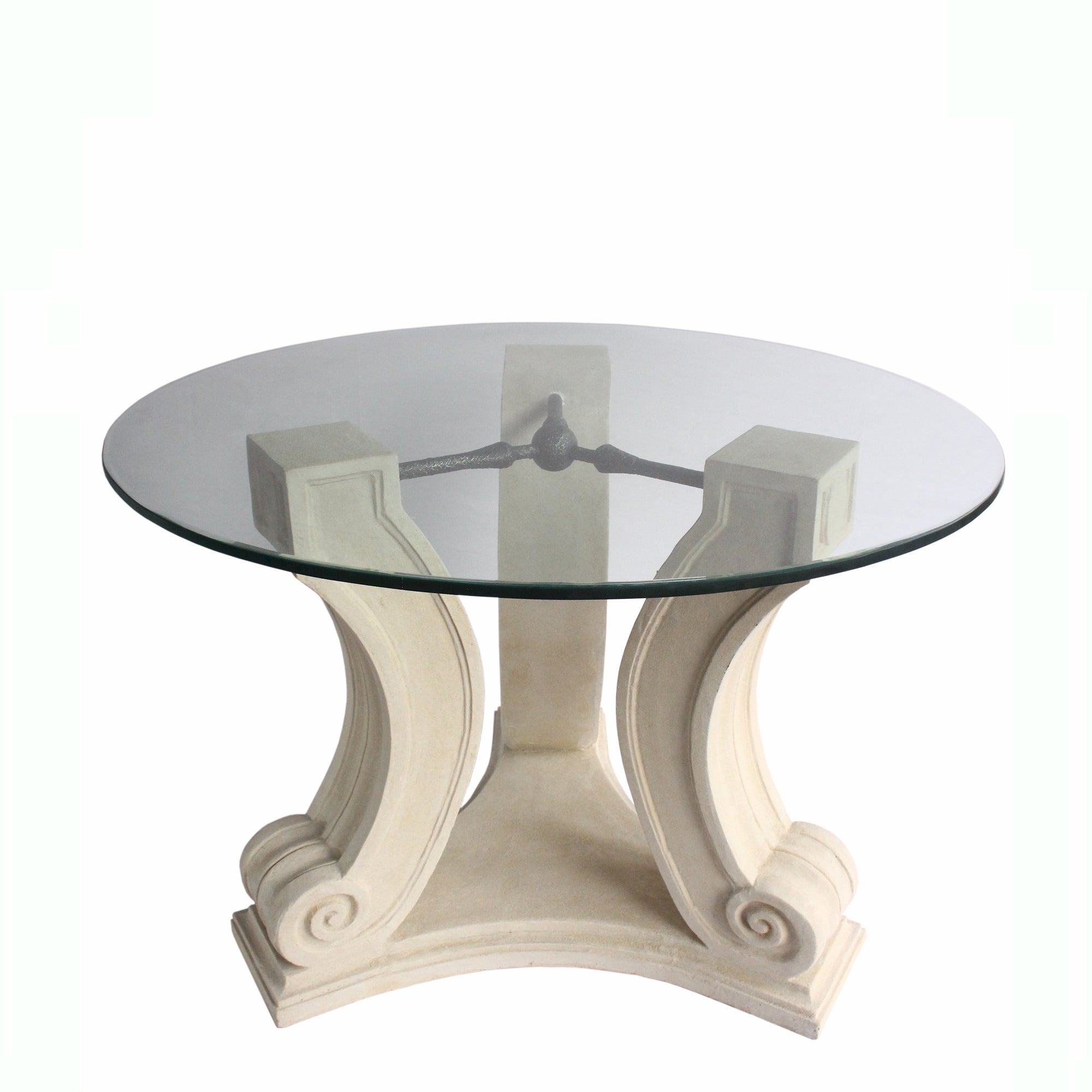 Round glass table with decorative white base on a white background