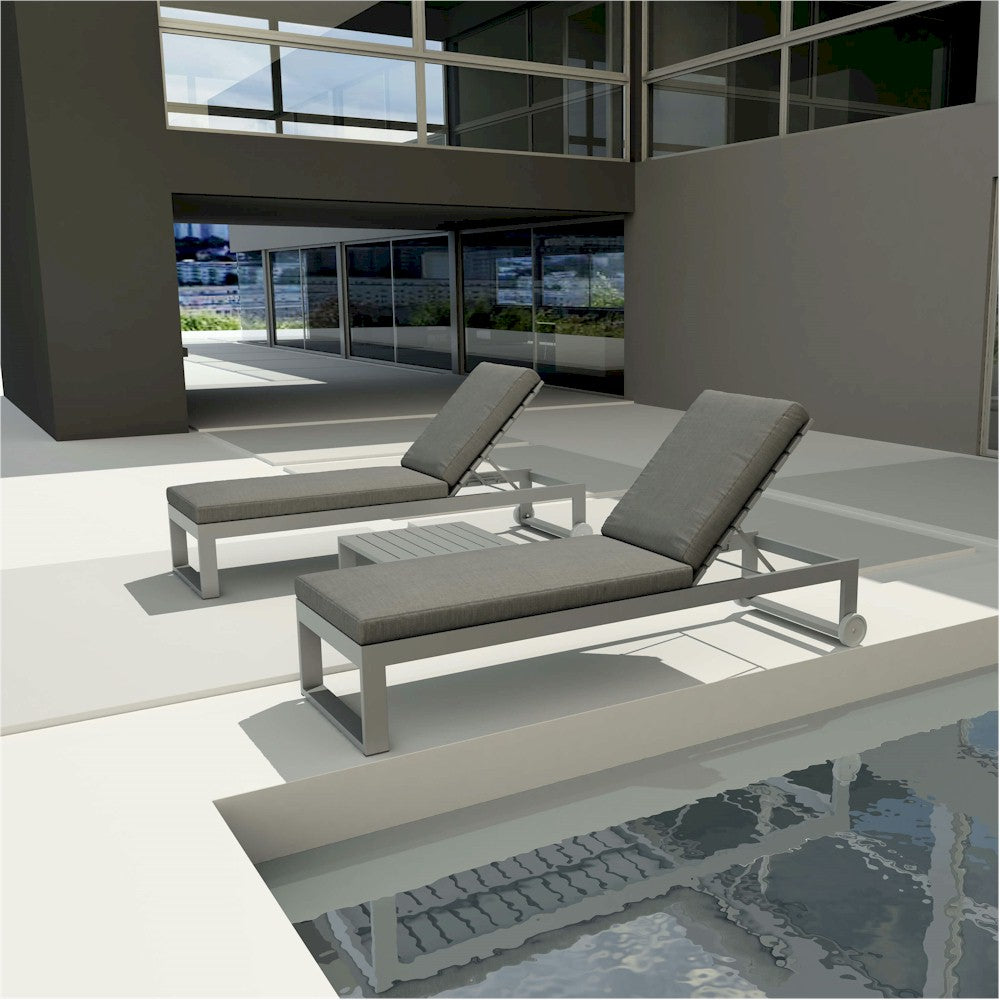 Two gray lounge chairs by a poolside with a building in the background