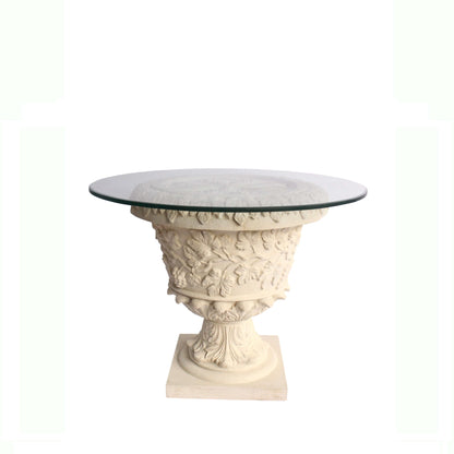 Decorative table with classical design and glass top on a white background