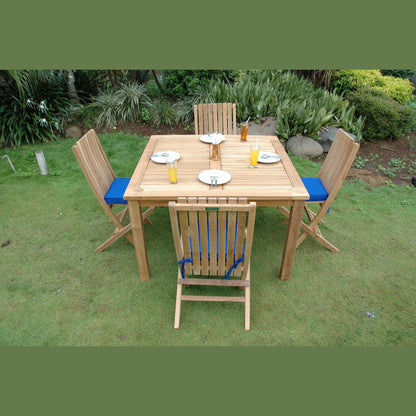 Wooden outdoor dining set with four chairs on a grassy area