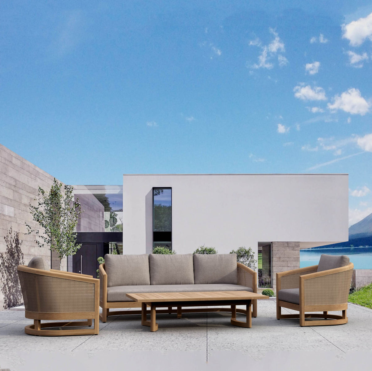 Outdoor patio set with sofa, chairs, and table against a blue sky.