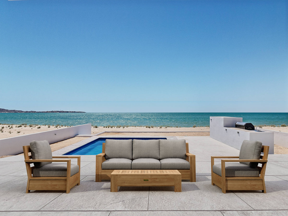 Outdoor furniture set with beige cushions by a pool and ocean view
