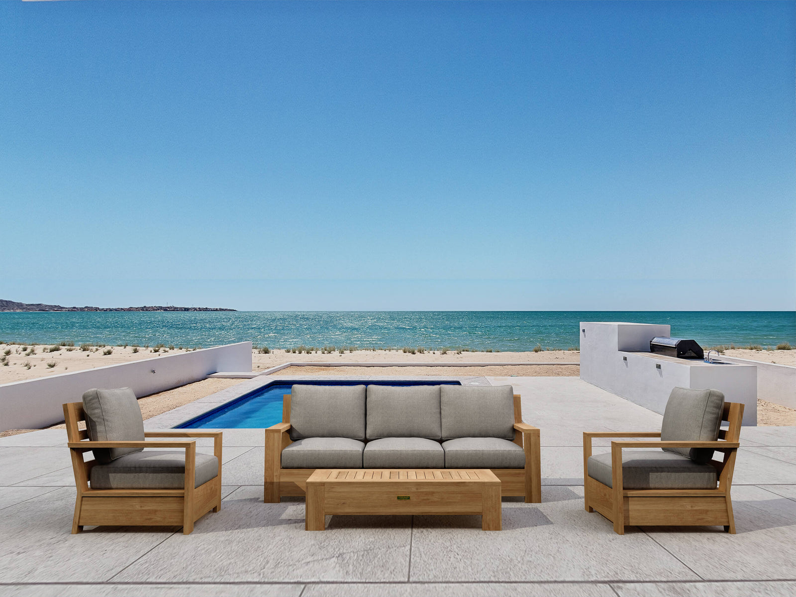 Outdoor furniture set with beige cushions by a pool and ocean view
