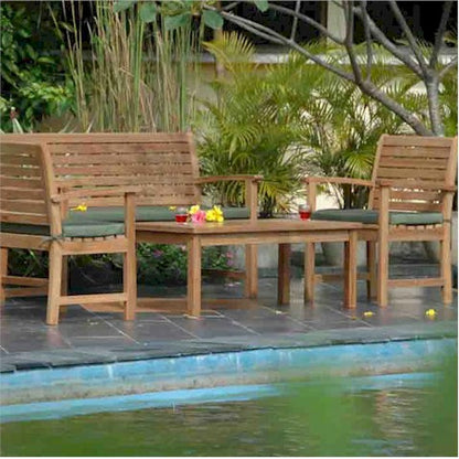 Wooden outdoor furniture set with green cushions by a poolside.