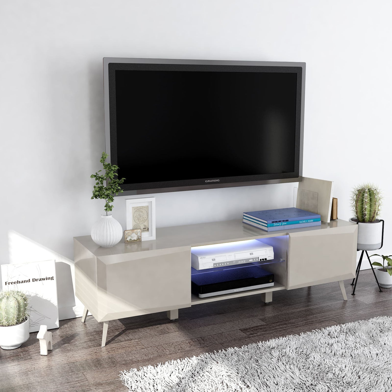 Modern TV stand with a television mounted on a white wall, featuring decorative items.