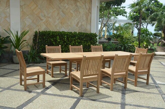 Wooden outdoor dining set with chairs on a patio