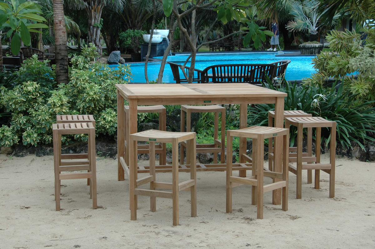 Wooden outdoor furniture set with table and stools near a pool