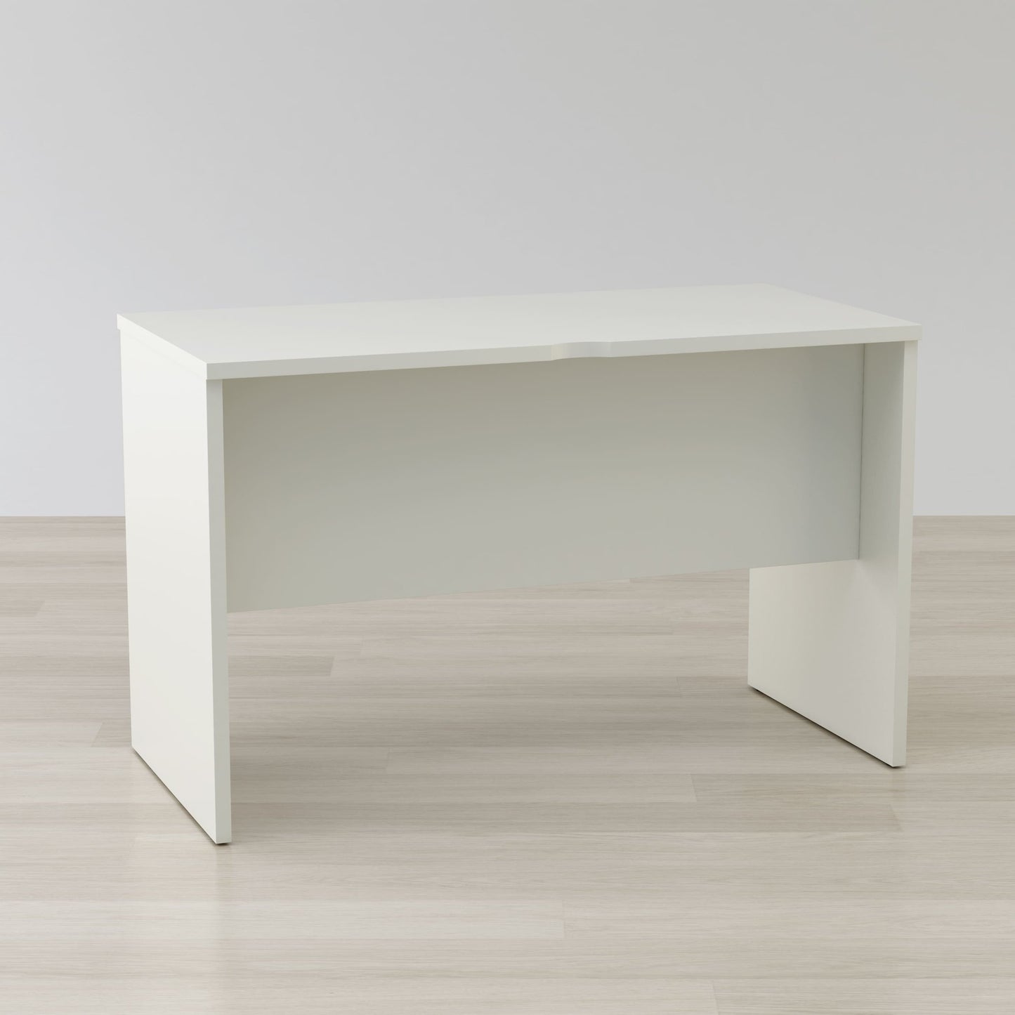 White desk on a light wooden floor with a plain white wall background