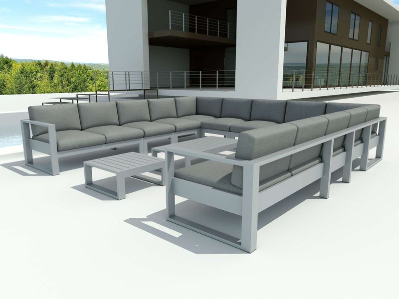 Outdoor patio furniture set with gray cushions on a clear day.