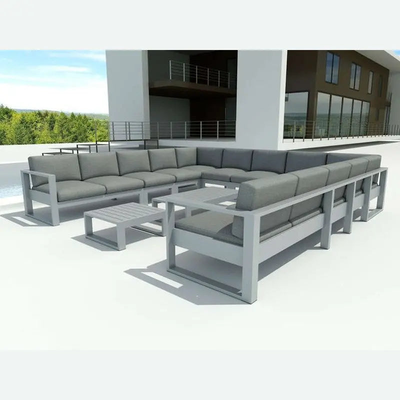 Outdoor patio furniture set with gray cushions on a clear day.