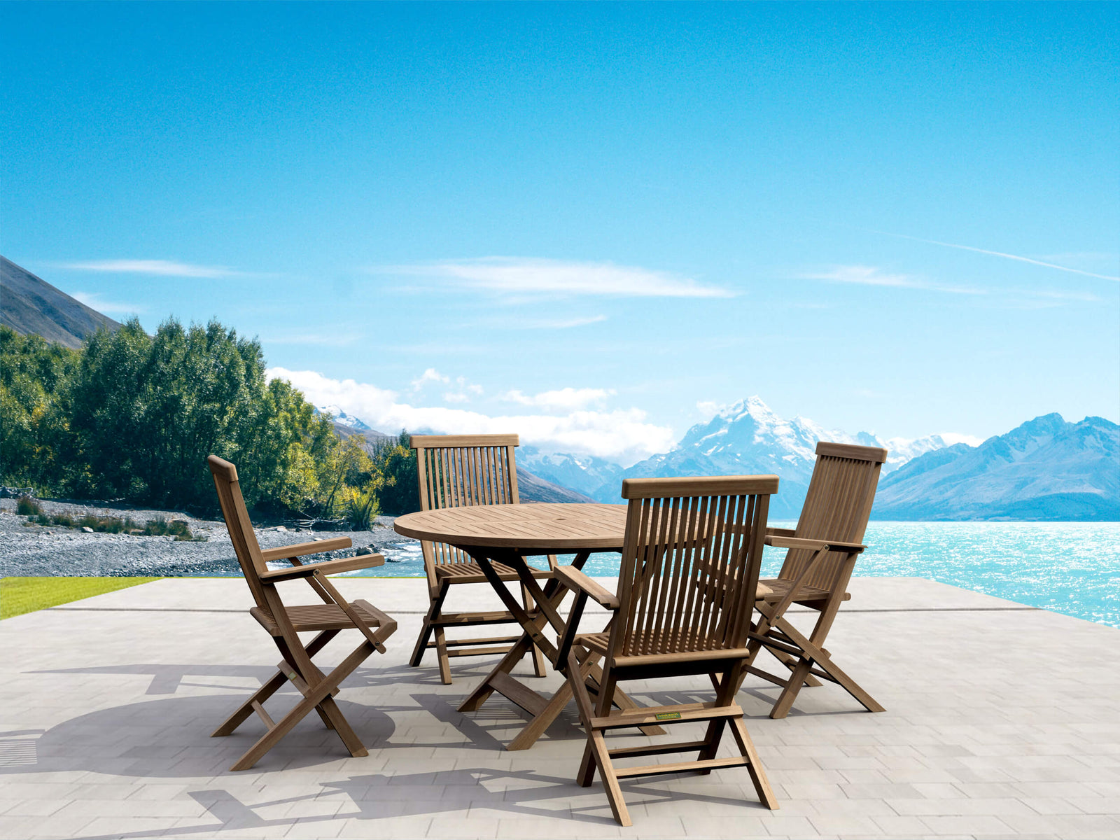 Wooden outdoor dining set with chairs on a patio overlooking mountains and water.