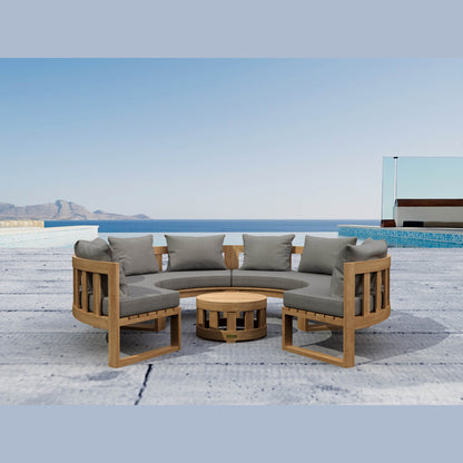 Outdoor patio furniture set with wooden frame and gray cushions by a pool and ocean view.