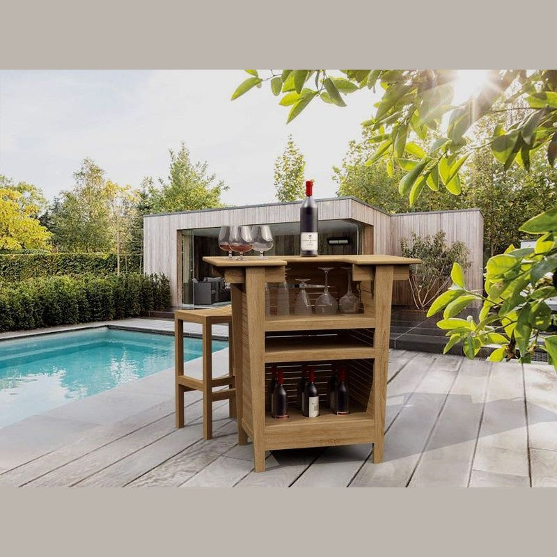 Outdoor kitchen island with bottles and glasses by a poolside