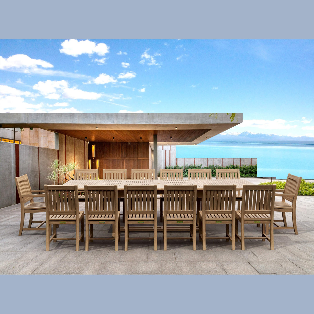 Outdoor dining set with a large table and chairs on a patio with a scenic background.