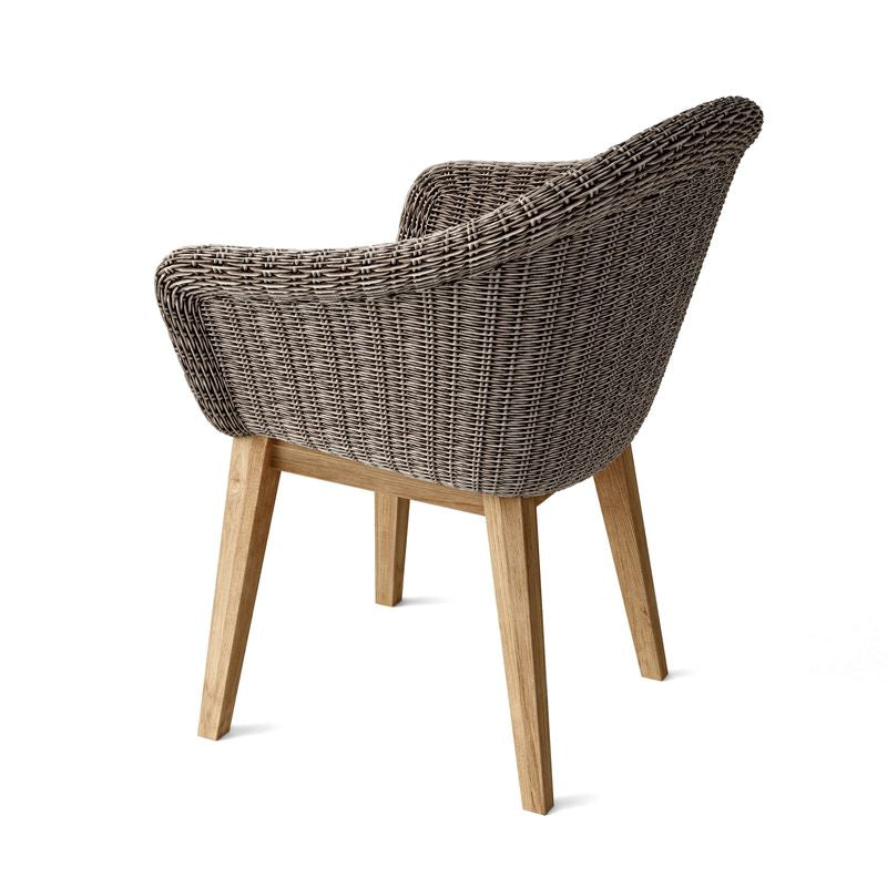 Wicker chair with wooden legs on a white background