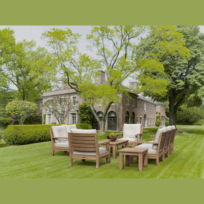 Outdoor furniture set on a well-manicured lawn with a historic building in the background