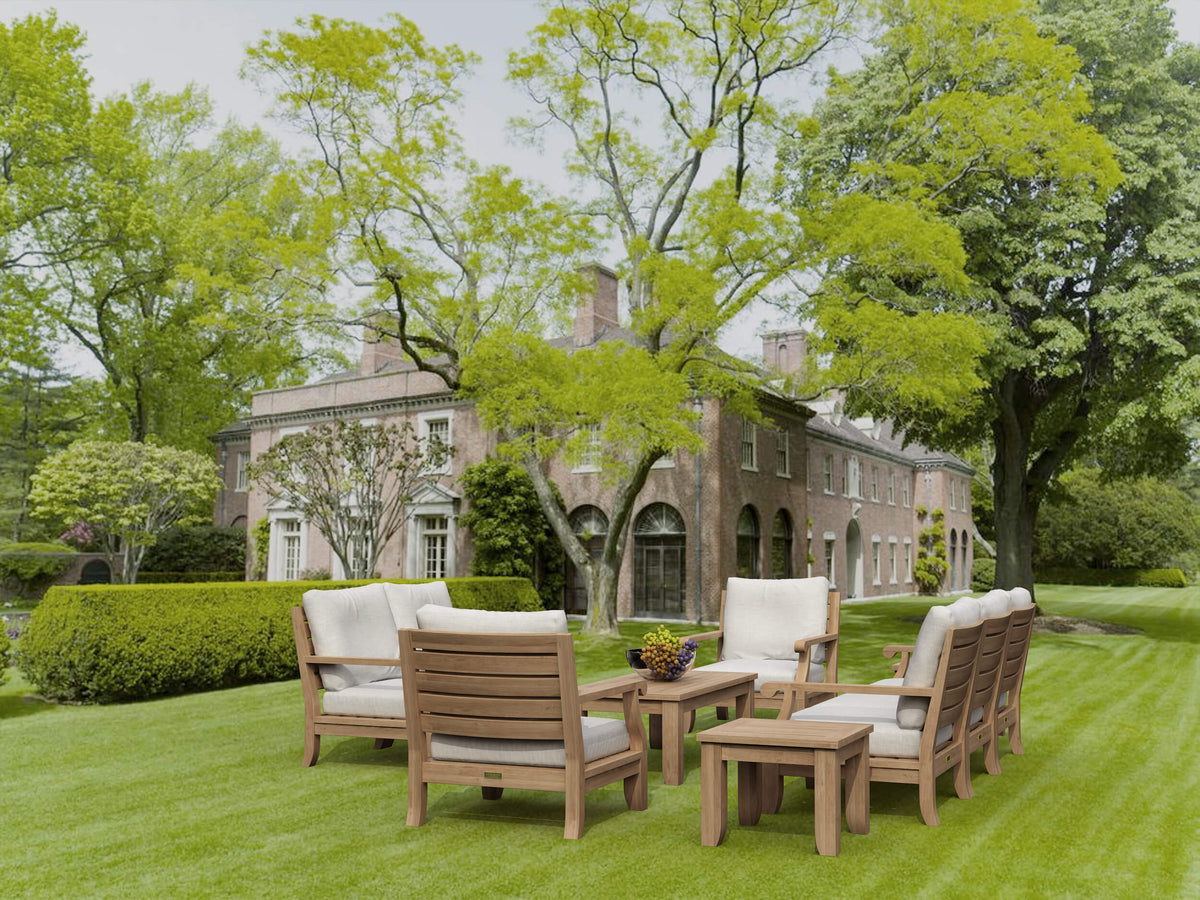 Outdoor furniture set on a well-manicured lawn with a historic building in the background