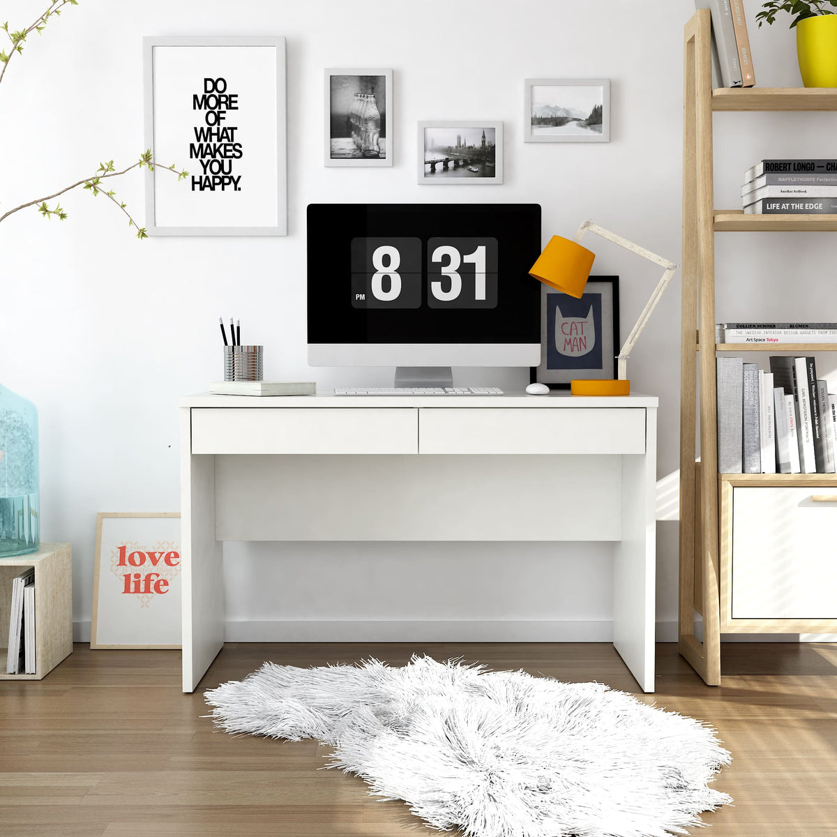 Modern home office with a white desk, computer monitor, and decorative elements.