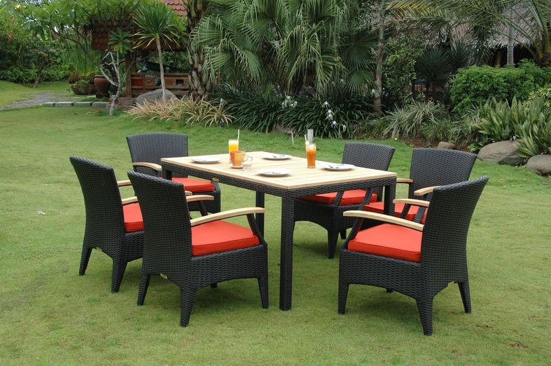 Outdoor furniture set with a table and chairs on grass