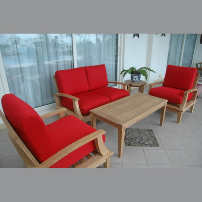 Red outdoor furniture set with wooden table on a patio