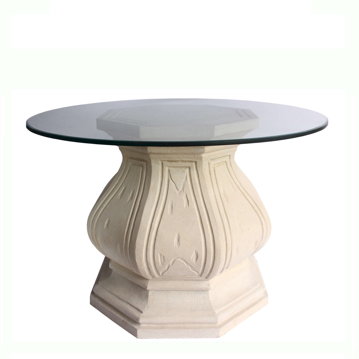 Round glass-top table with decorative beige base on a white background