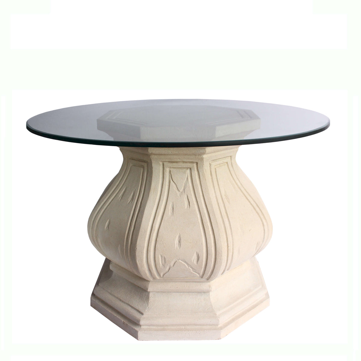 Round glass-top table with decorative beige base on a white background