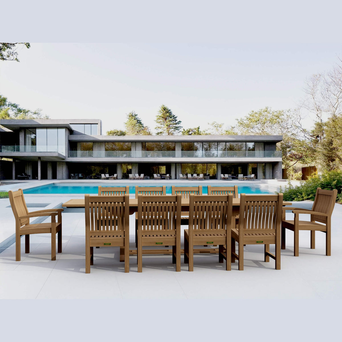Wooden outdoor dining set with chairs near a modern house and pool.