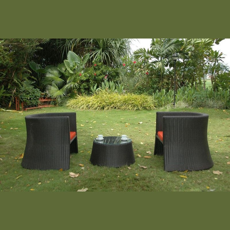 Black outdoor furniture set on a grassy area with greenery in the background