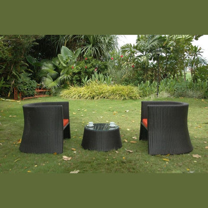 Black outdoor furniture set on a grassy area with greenery in the background