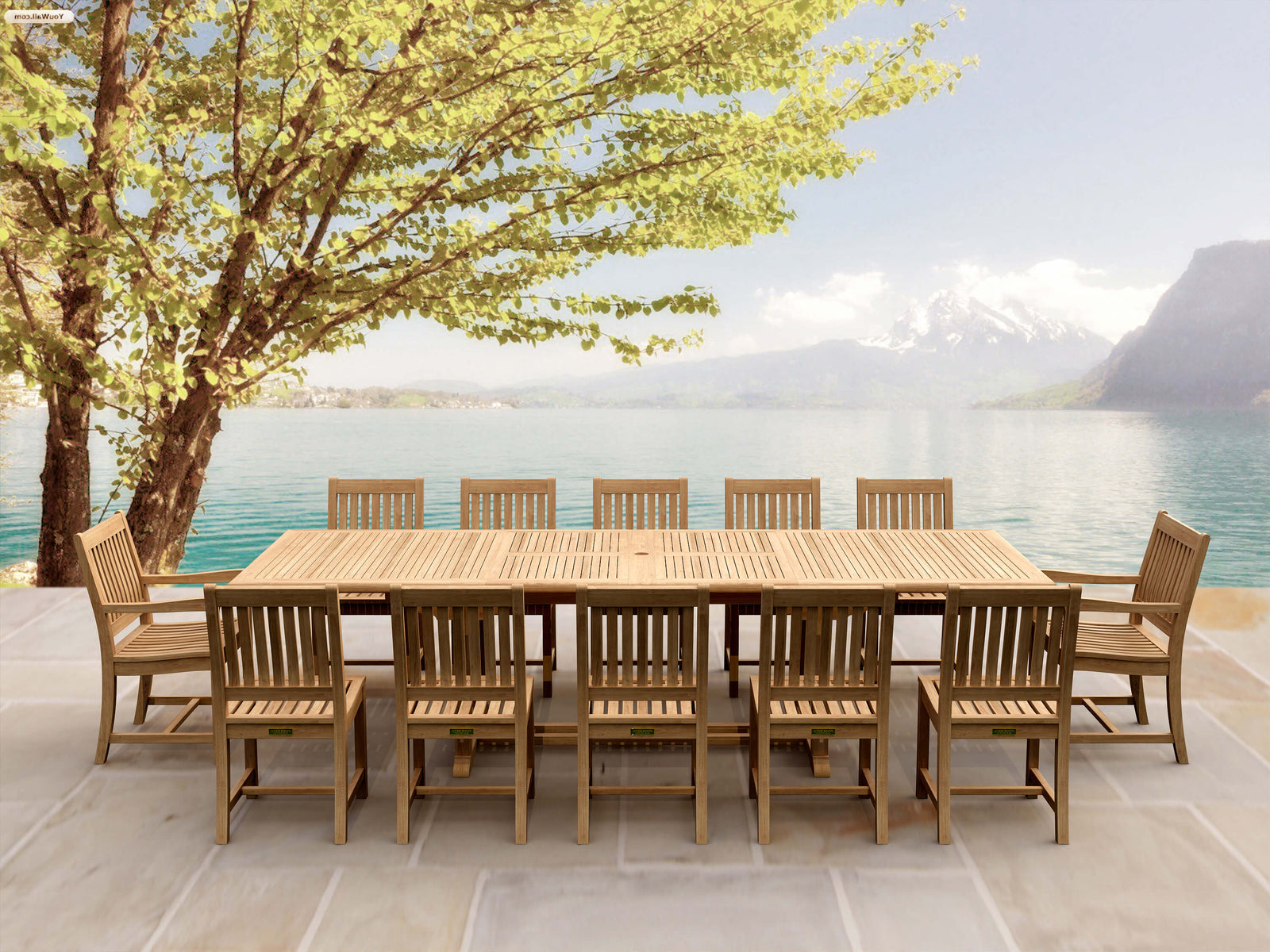 Wooden outdoor dining set with chairs by a lake and mountains