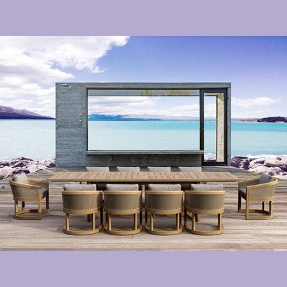 Outdoor dining area with a large flat-screen TV mounted on a wall overlooking a scenic lake.