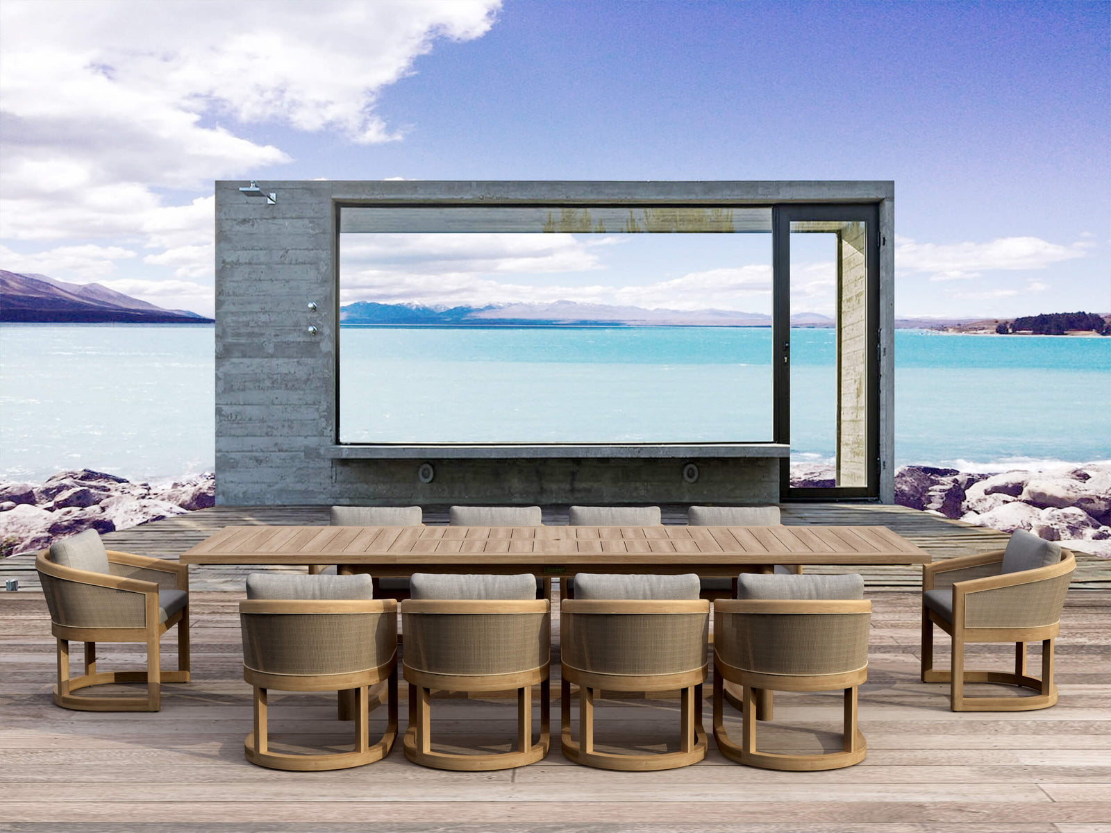 Outdoor dining area with a large flat-screen TV mounted on a wall overlooking a scenic lake.