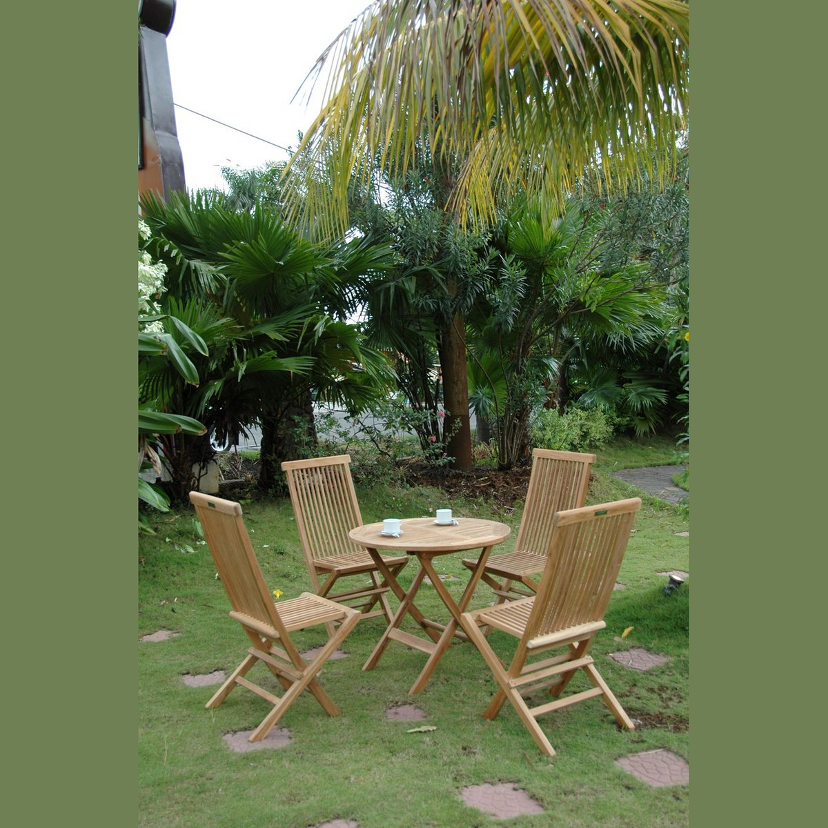 Wooden outdoor furniture set with four chairs around a small round table in a garden setting.