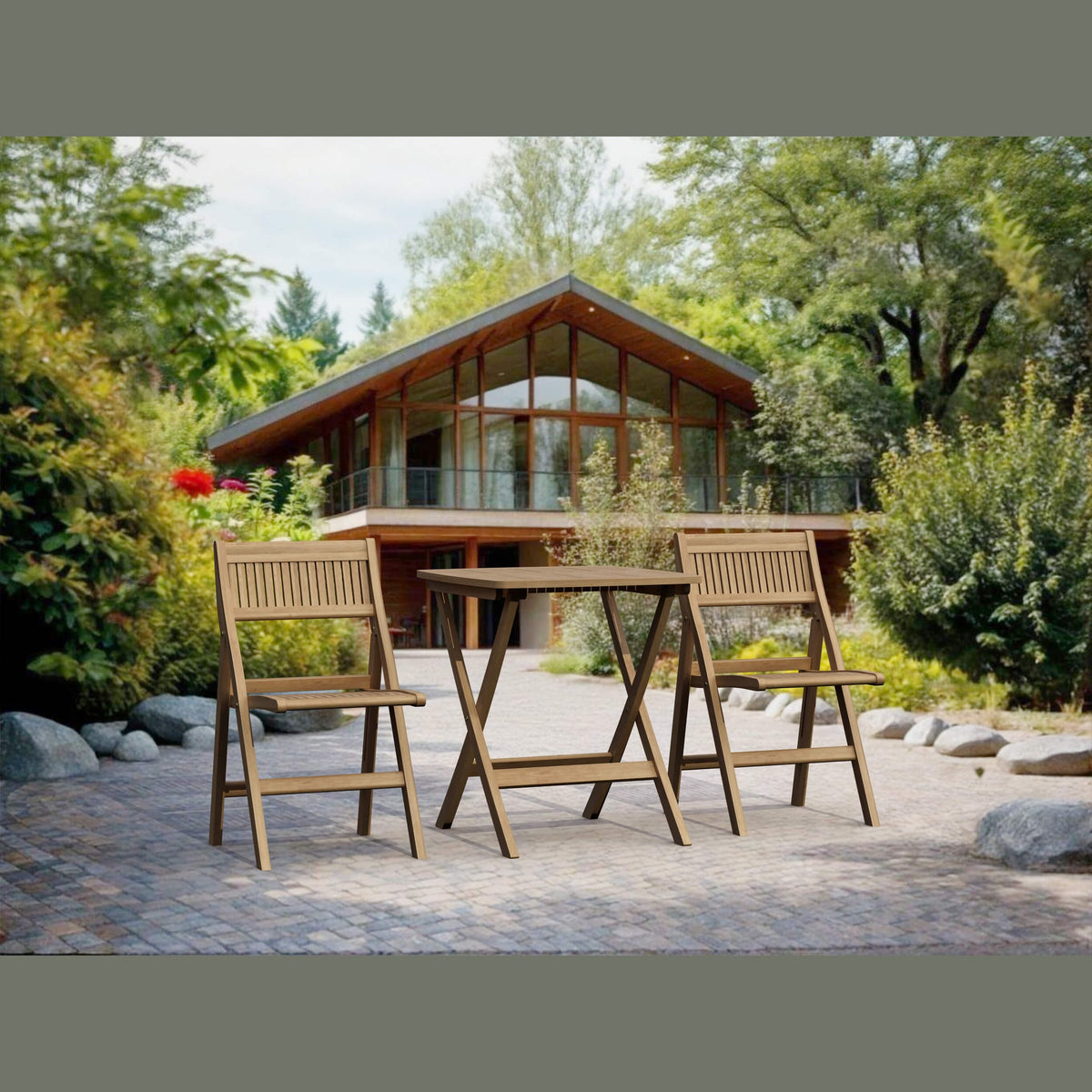 Wooden outdoor table and chairs in front of a modern house with a green, tree-filled landscape.