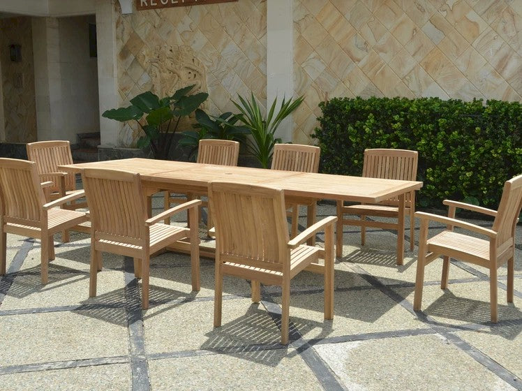 Wooden outdoor dining set with table and chairs on a stone patio.
