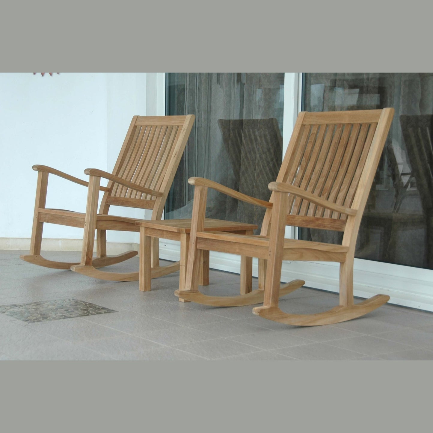 Two wooden rocking chairs on a patio