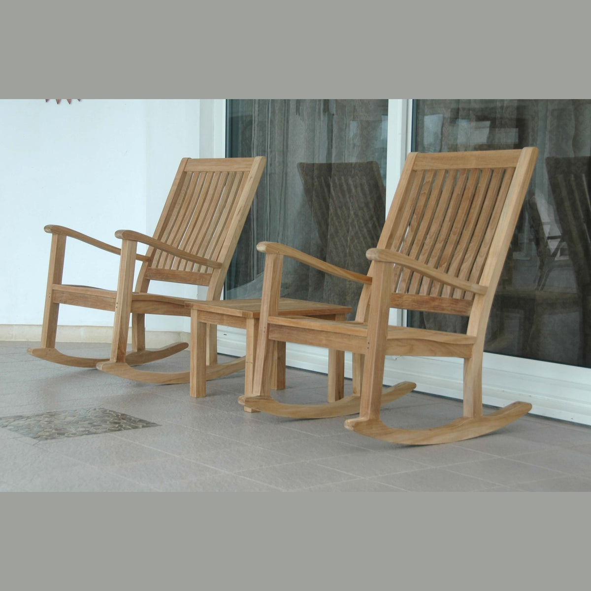 Two wooden rocking chairs on a patio
