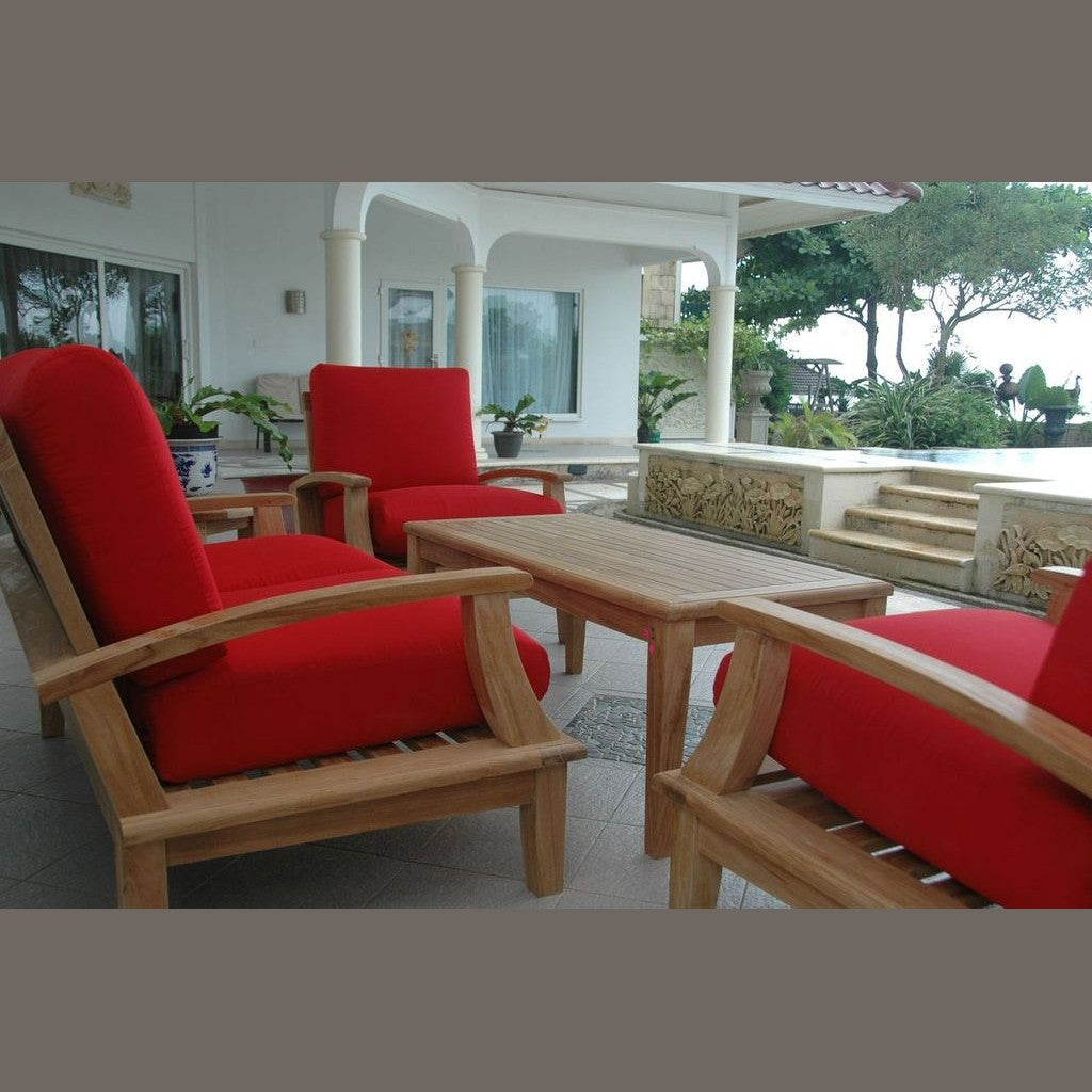 Outdoor furniture set with red cushions and wooden frames on a patio.