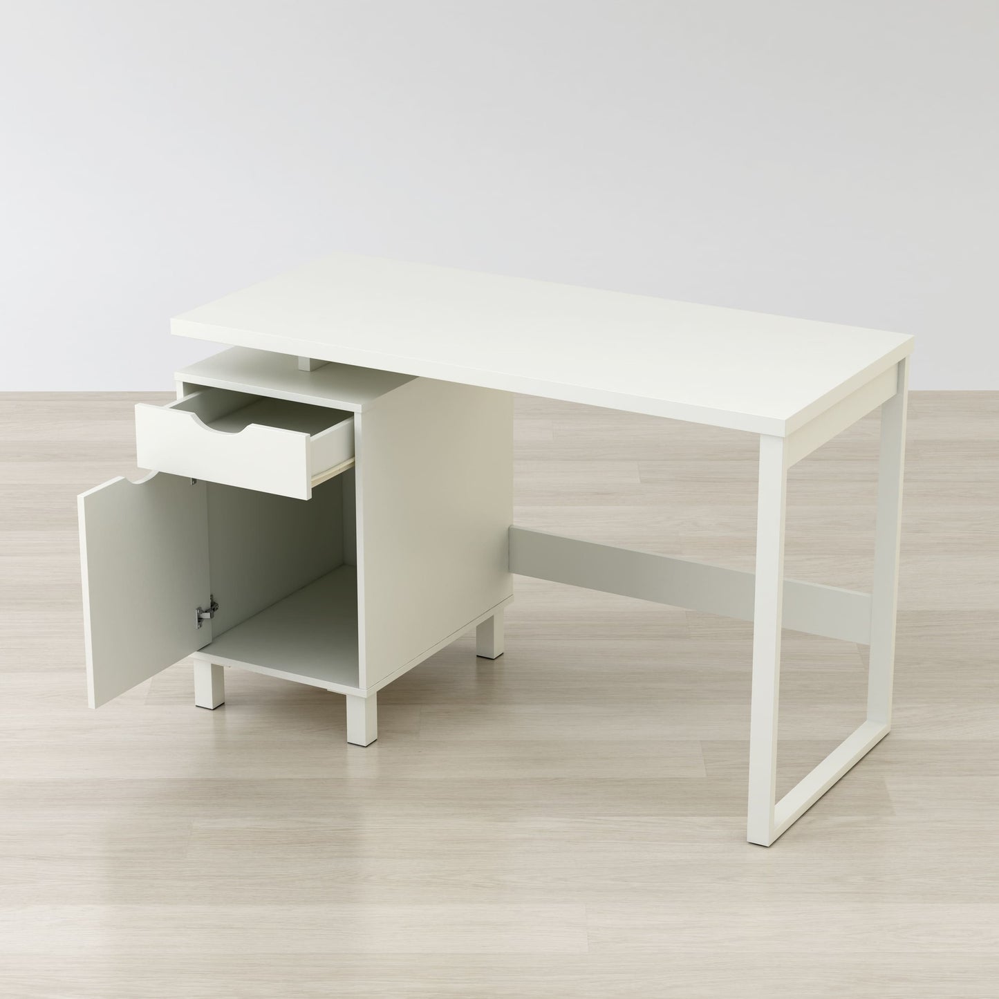 White office desk with a drawer on a light wooden floor.