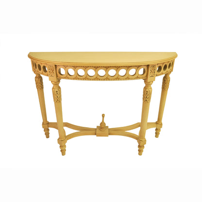 Decorative yellow console table with intricate carvings on a white background