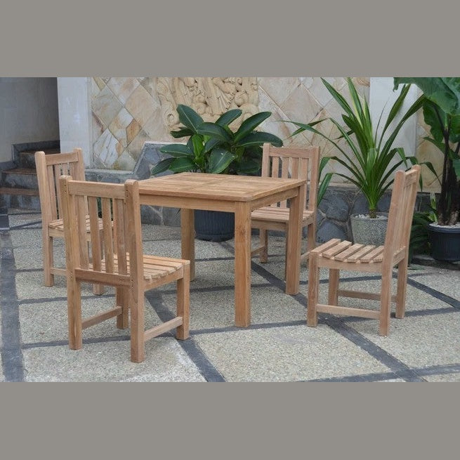 Wooden outdoor dining set with four chairs on a stone patio.