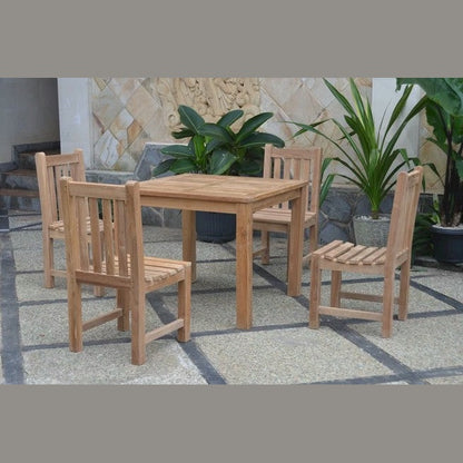 Wooden outdoor dining set with four chairs on a stone patio.