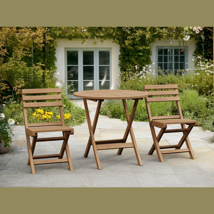 Wooden outdoor table and chairs set on a patio with a garden background
