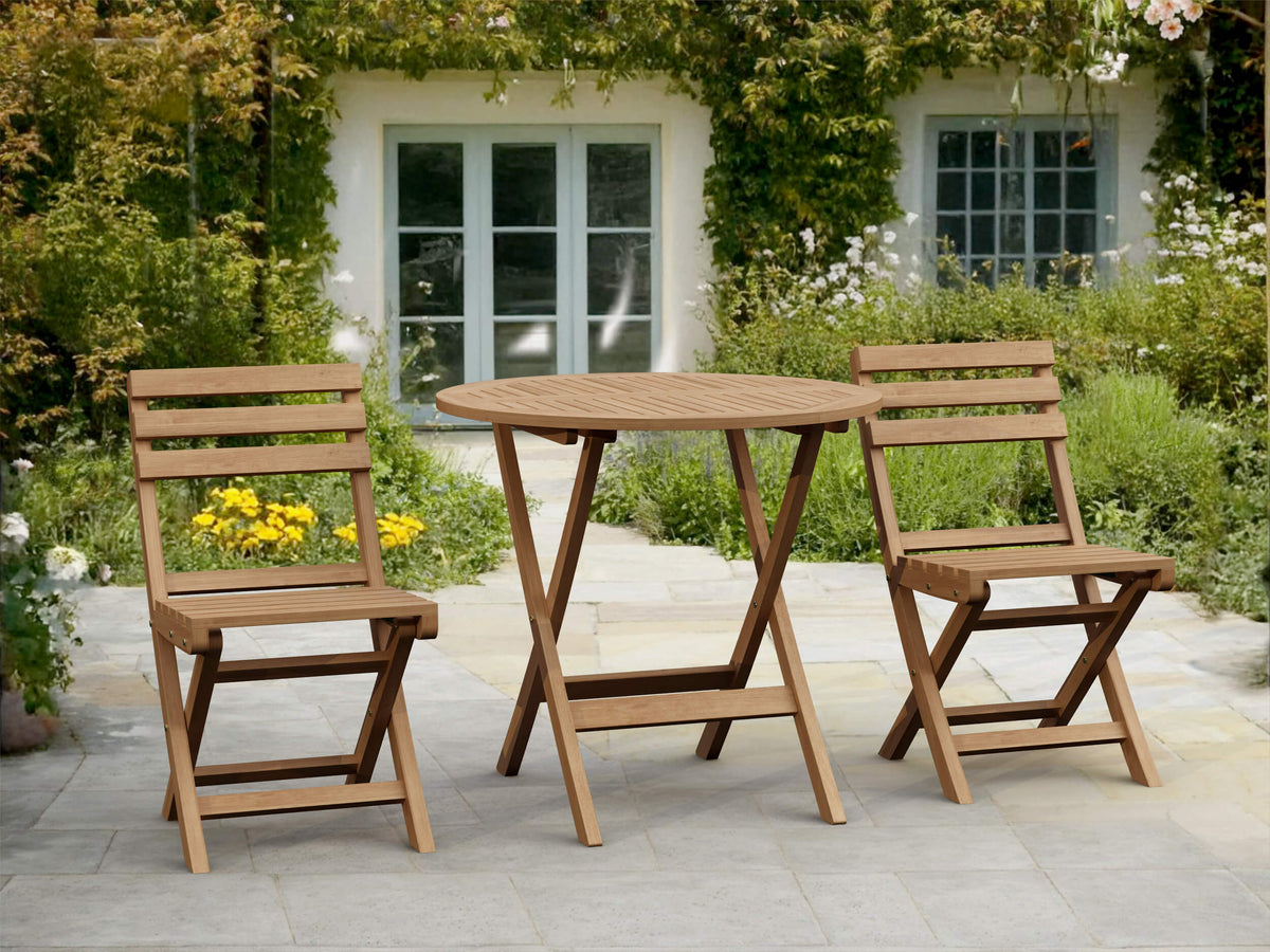Wooden outdoor table and chairs set on a patio with a garden background